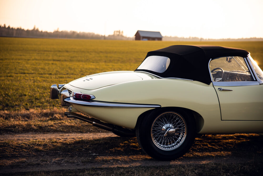 Vintage convertible car in sunset-lit field