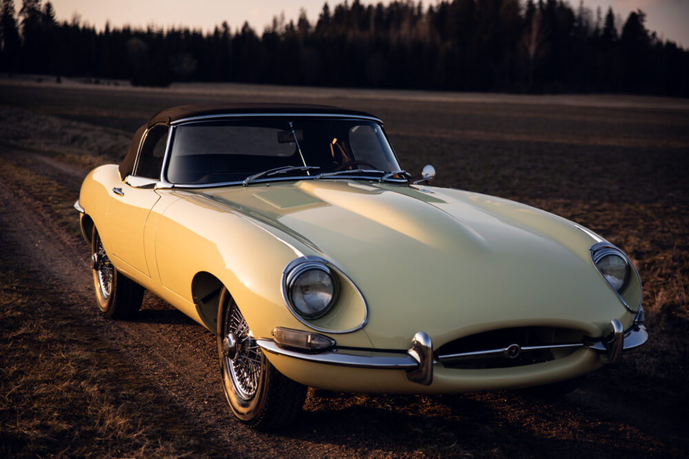 Vintage yellow sports car in sunset field