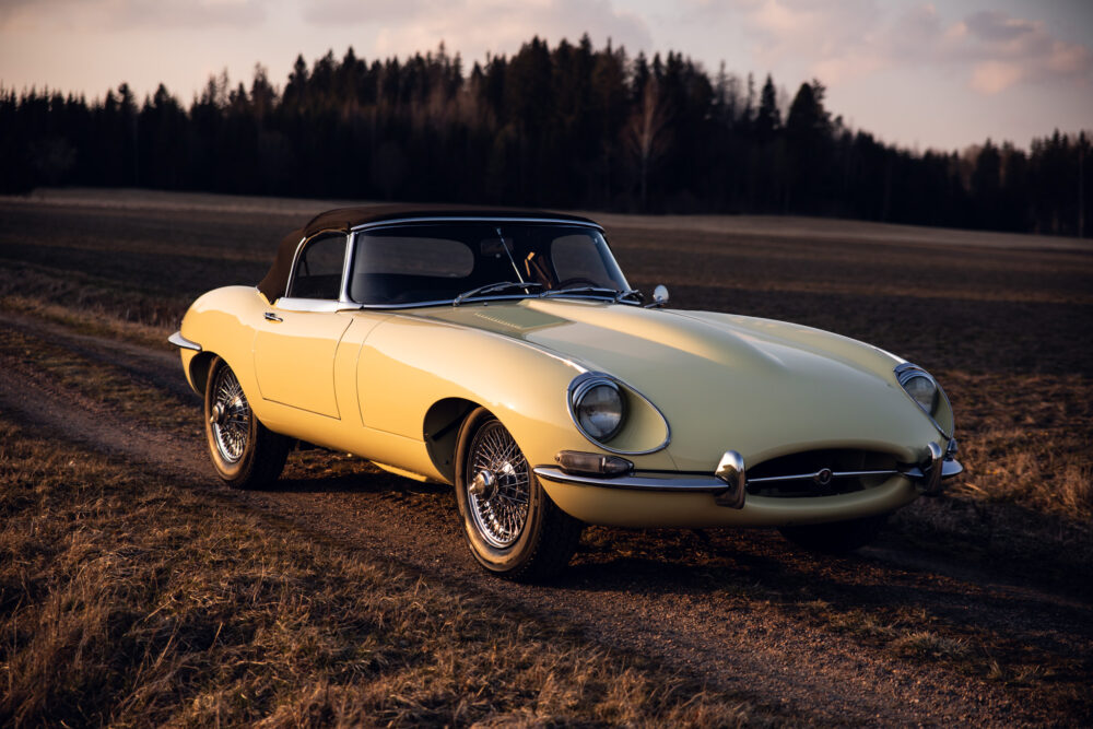 Vintage yellow sports car in countryside at sunset