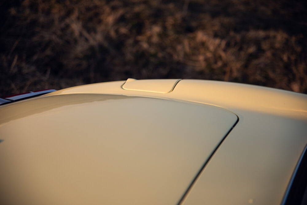 Closeup of car hood and scoop at sunset