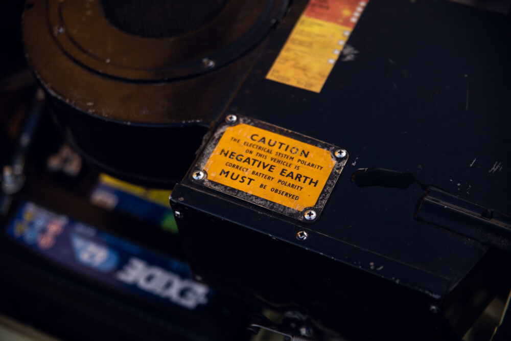 Caution sign on electrical system indicating negative earth