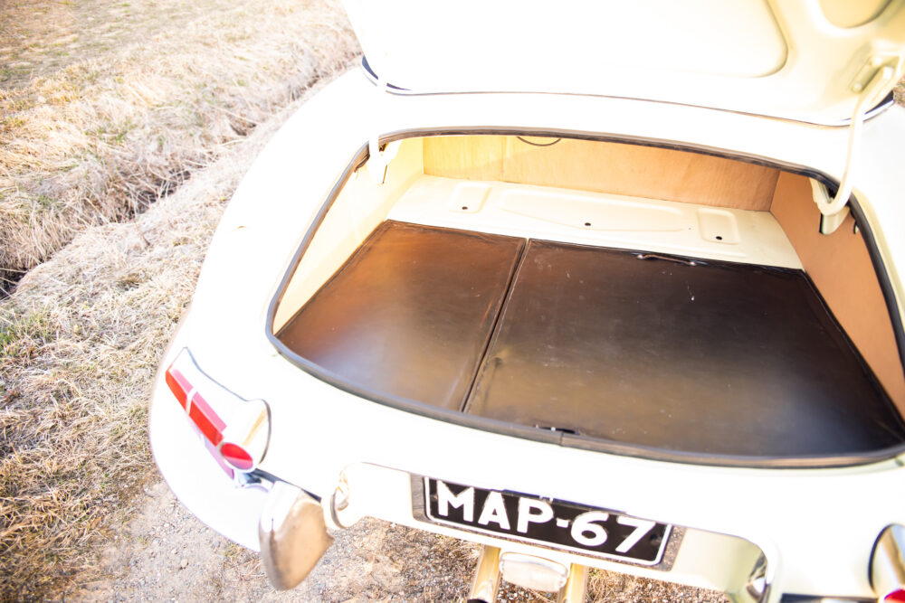 Open trunk of vintage car showing interior storage
