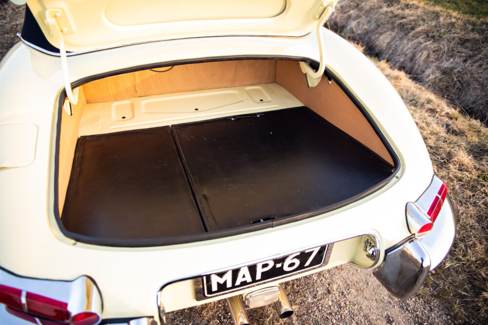 Open trunk of a vintage cream-colored car