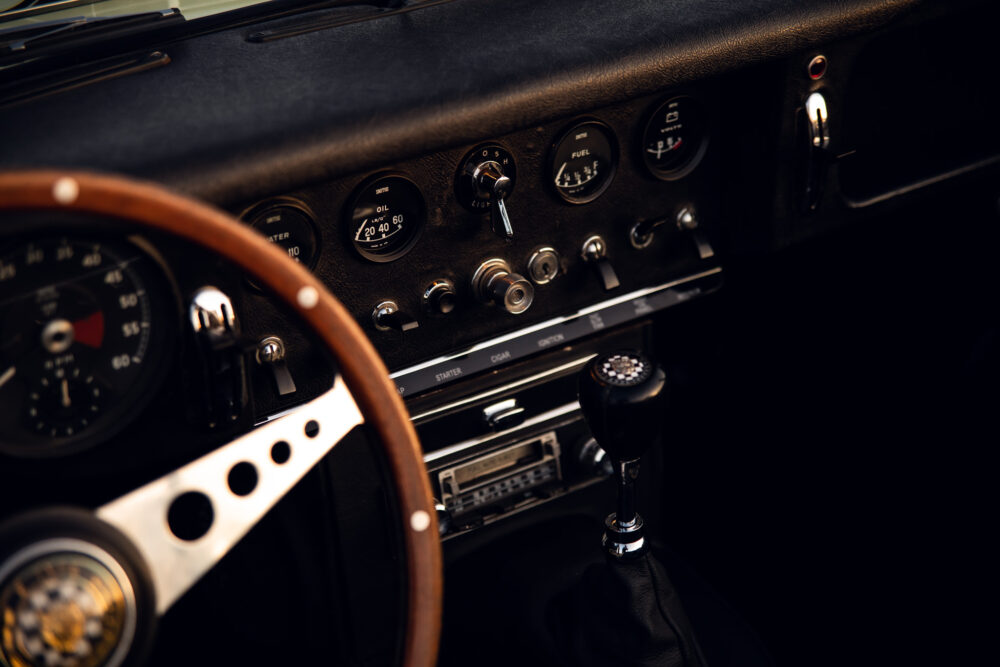 Vintage car dashboard with wooden steering wheel