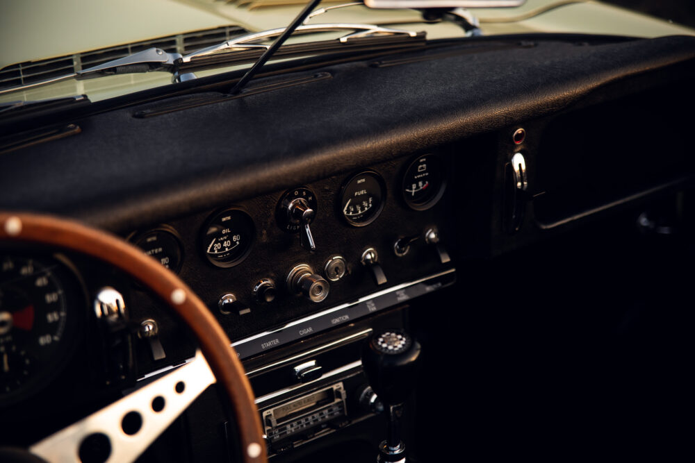 Vintage car dashboard with classic wooden steering wheel