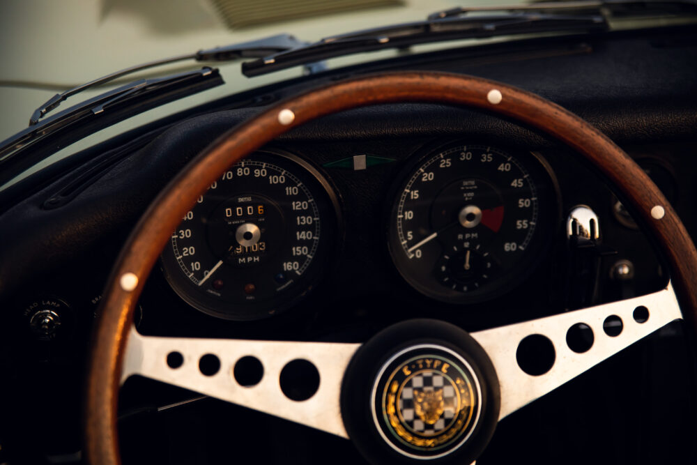 Vintage car dashboard with wooden steering wheel