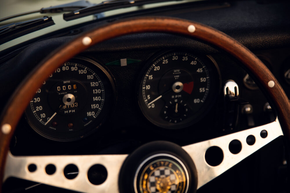 Vintage car dashboard with wooden steering wheel