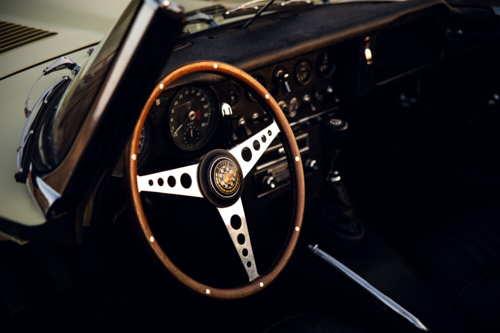 Vintage car dashboard with wooden steering wheel