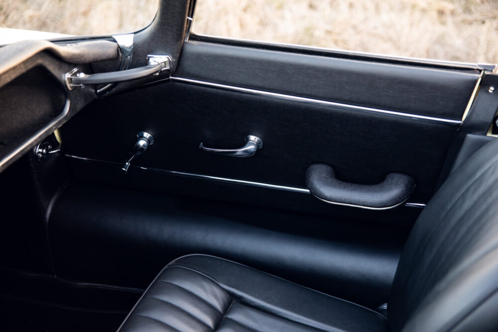 Classic car interior with leather seats and door handle