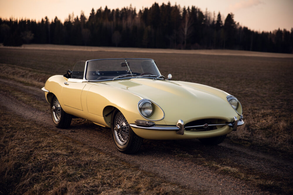 Vintage yellow convertible car parked on countryside road