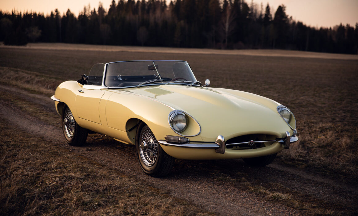 Vintage yellow convertible car parked on countryside road