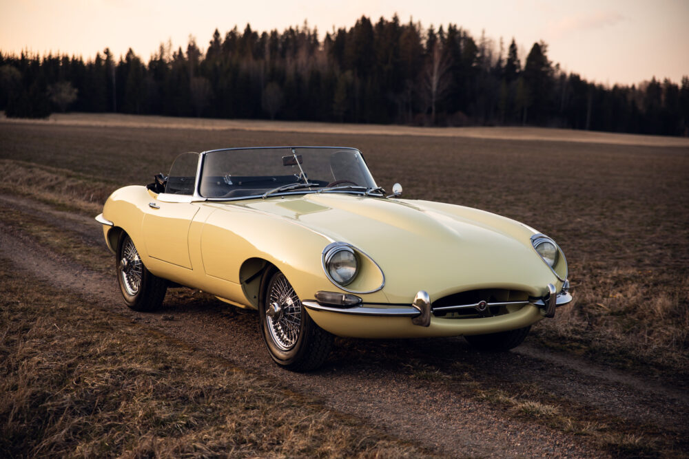 Vintage yellow convertible car parked in open field