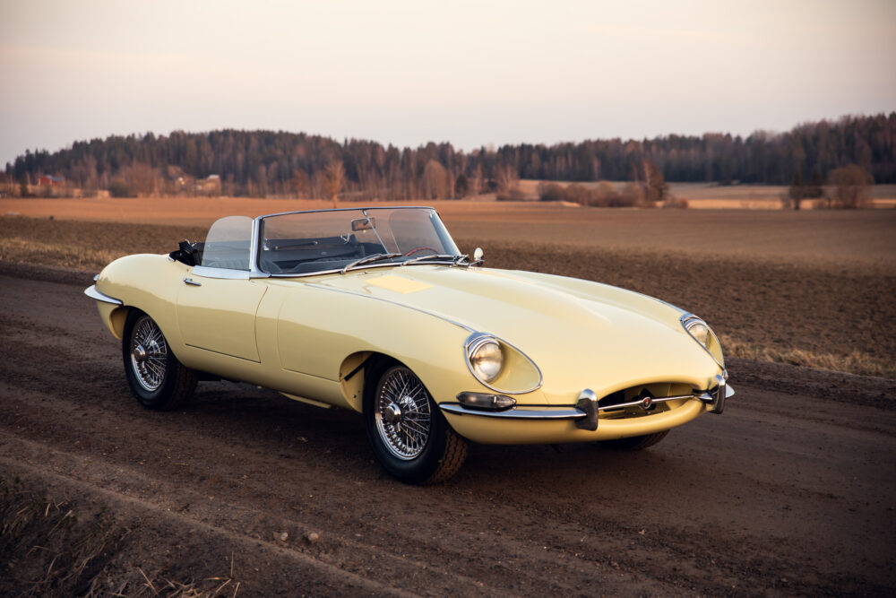 Yellow vintage convertible car on rural road