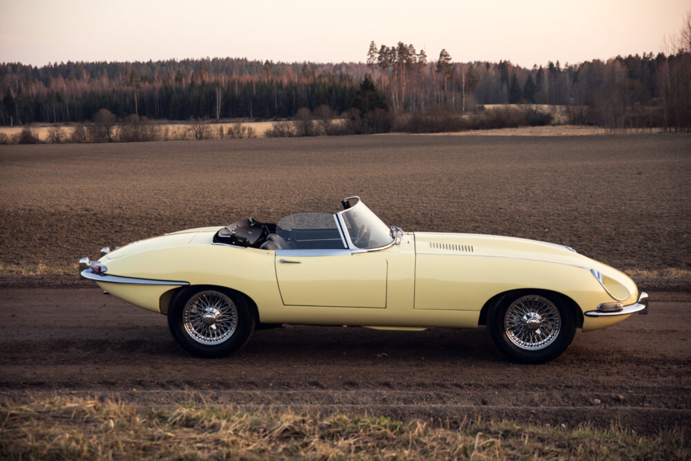 Vintage yellow convertible car parked in open field