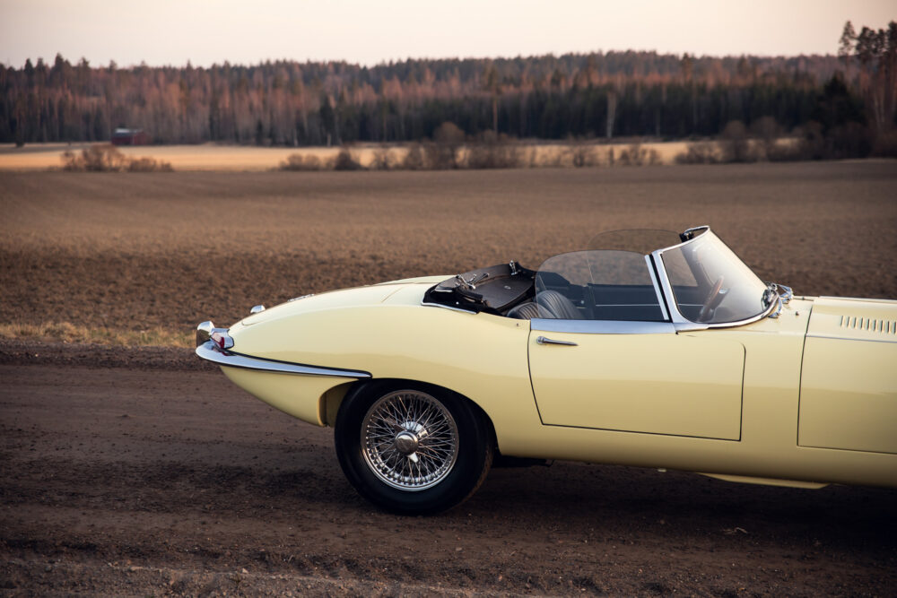 Vintage yellow convertible car on rural dirt road