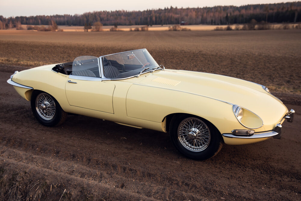 Vintage yellow convertible car in open field