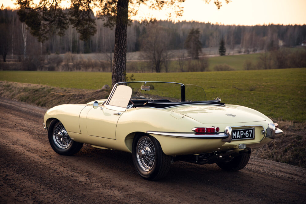 Vintage yellow convertible car on rural road at dusk