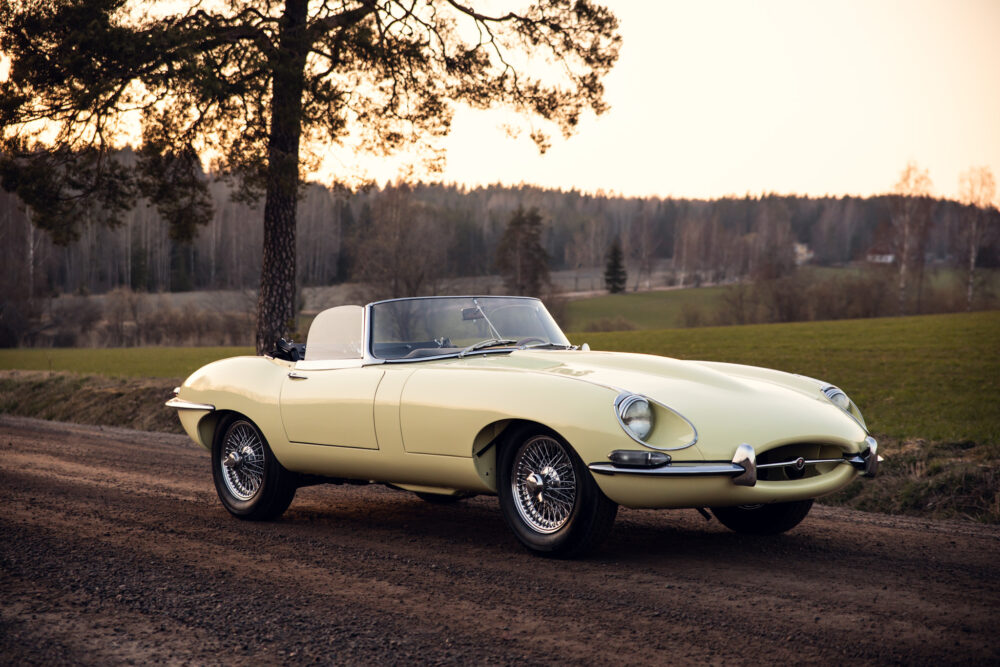 Vintage yellow convertible car parked on countryside road