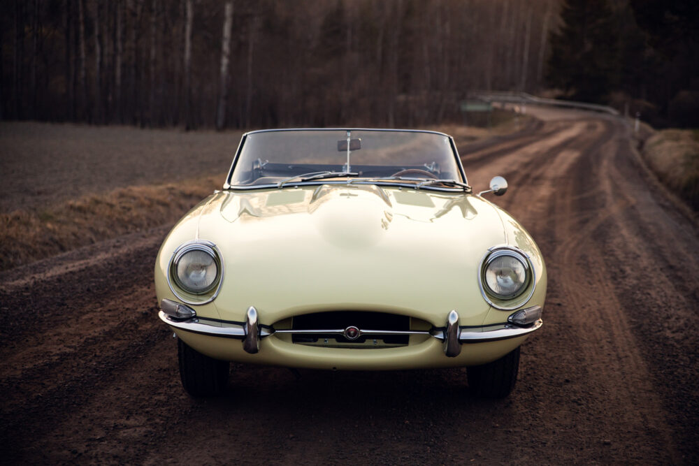 Vintage yellow convertible on forest road