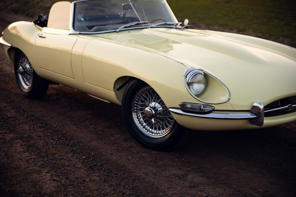 Classic yellow convertible car on a dirt road