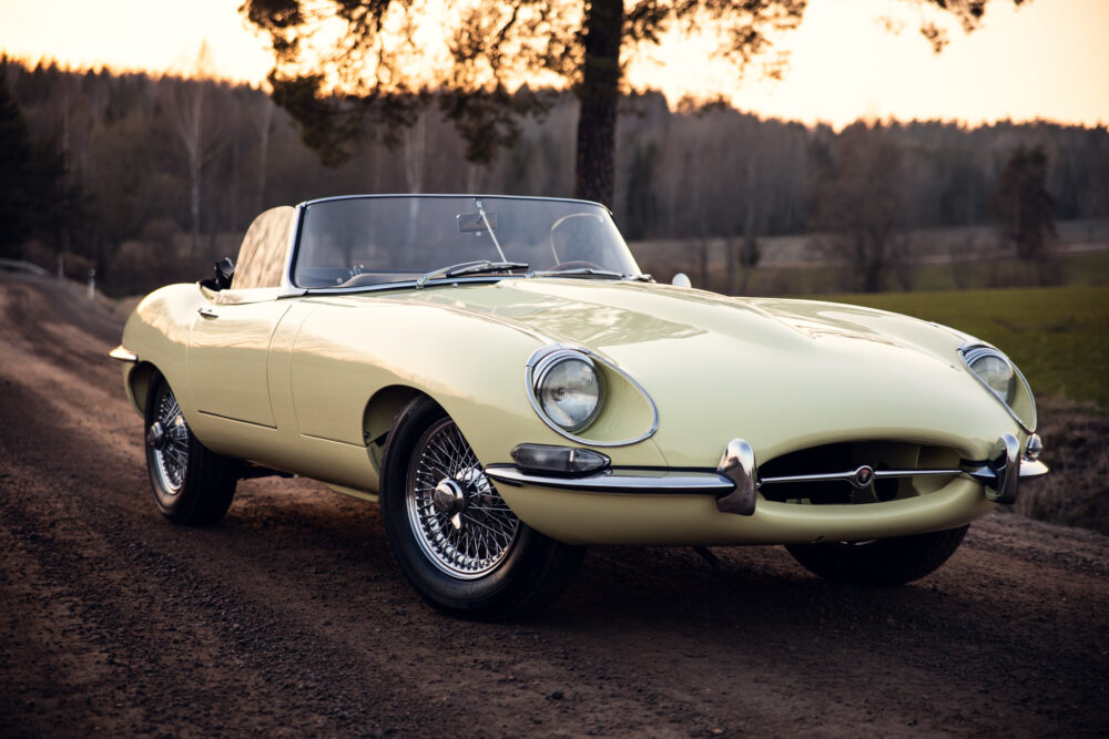 Vintage yellow sports car parked on countryside road