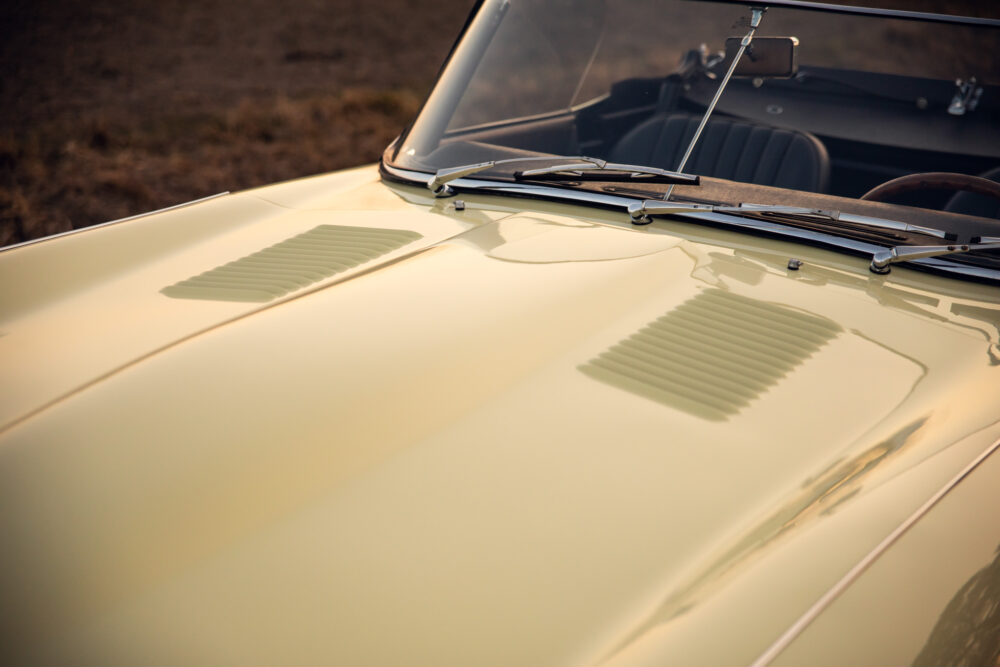 Vintage car hood and windshield at sunset