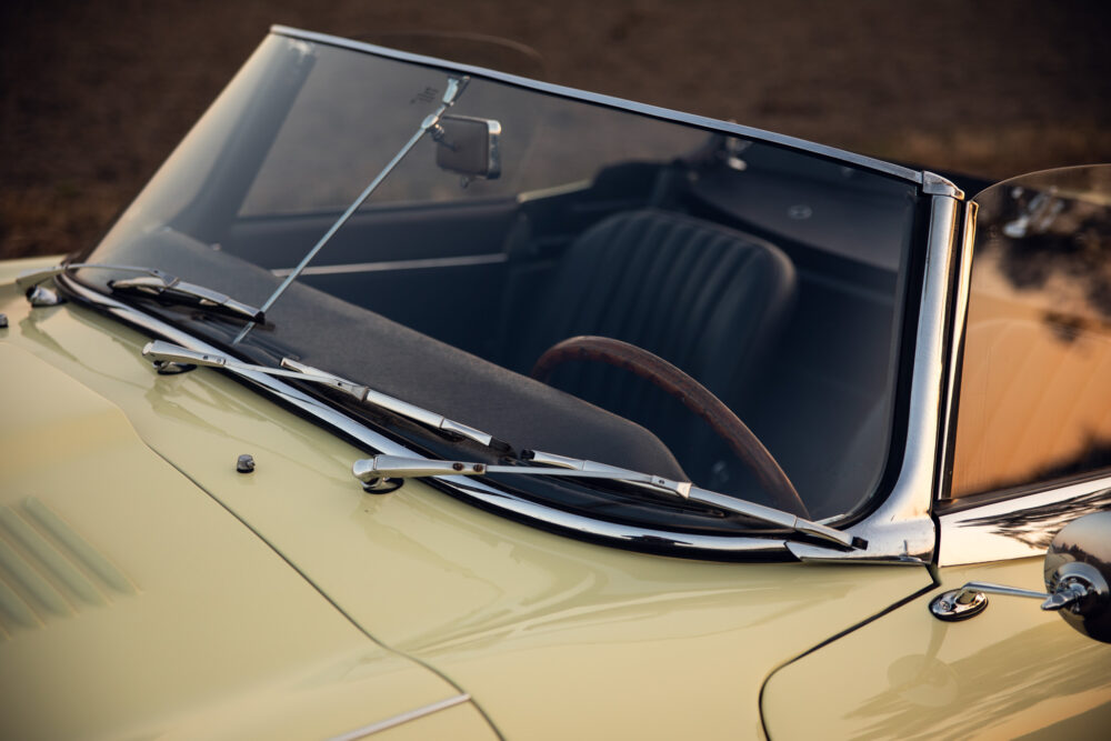 Classic car's windshield and dashboard at sunset