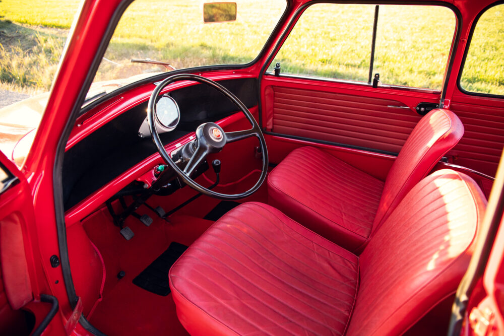 Vintage red car interior, steering wheel and seats