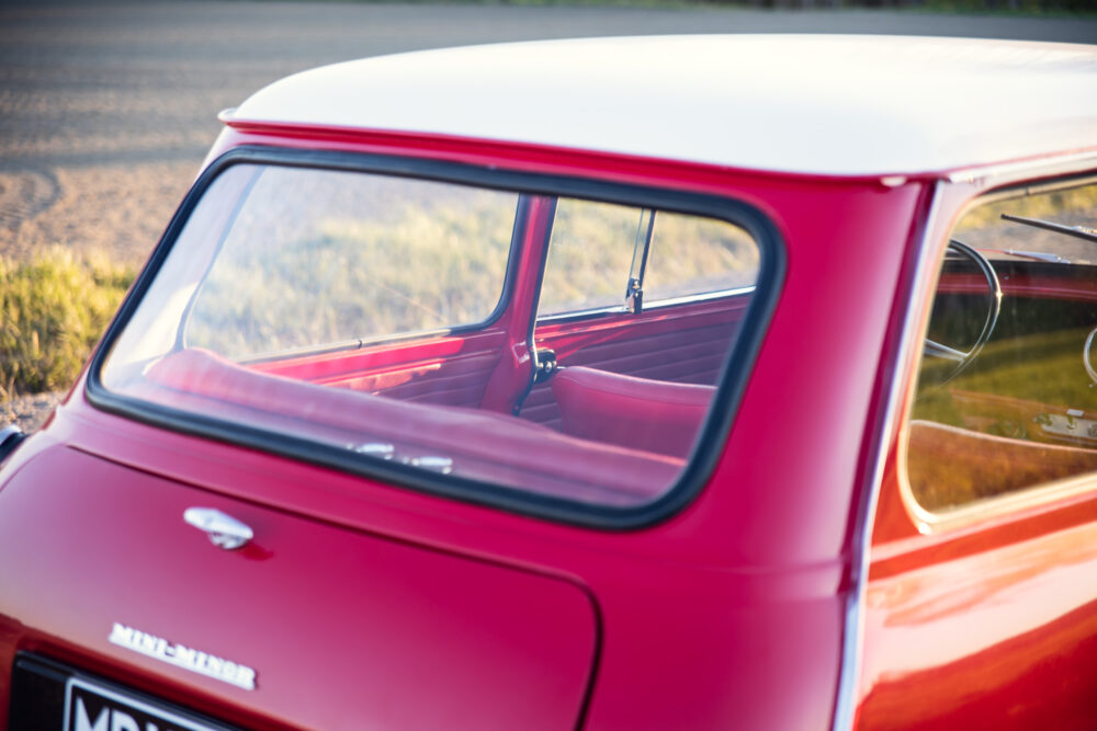 Vintage red Mini Cooper with white roof, detailed interior view