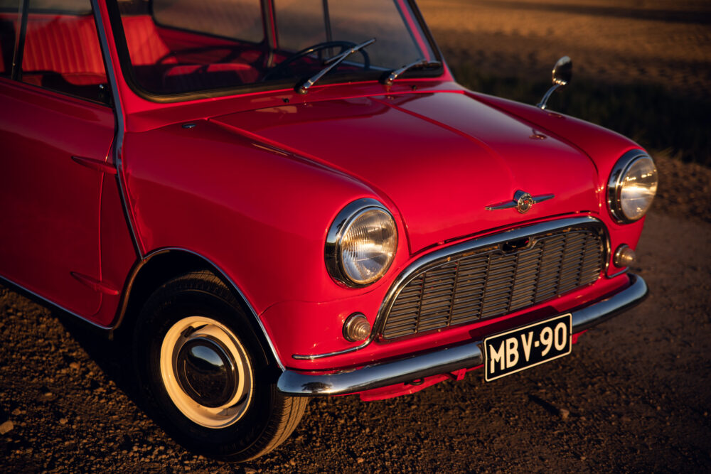 Vintage red car parked outdoors at sunset