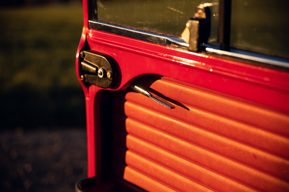 Close-up of red vehicle door with chrome handle