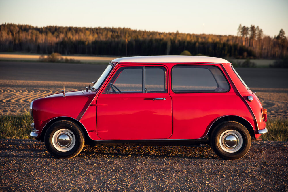 Vintage red Mini Cooper in scenic rural setting