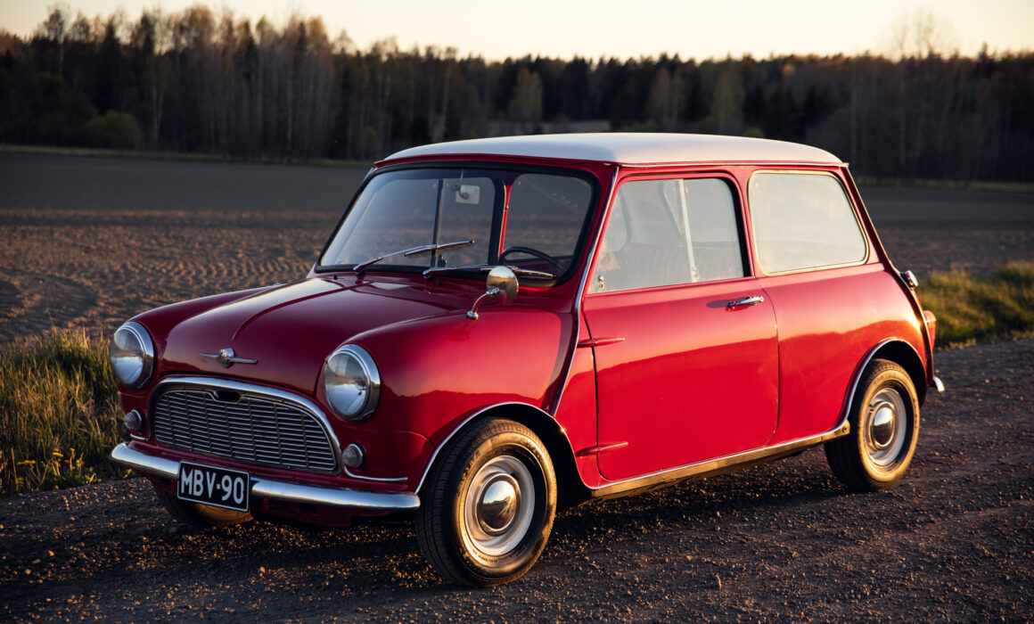 Vintage red Mini Cooper parked in rural setting