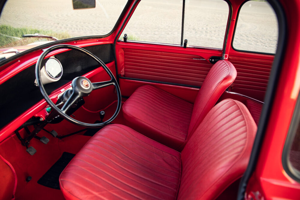 Vintage red car interior with classic steering wheel