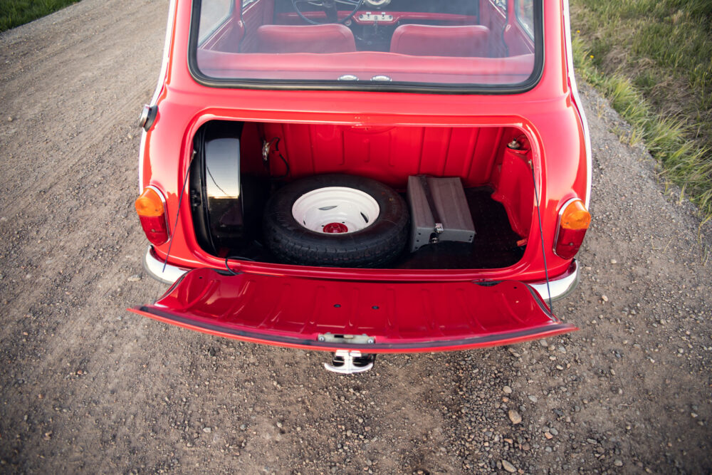 Red vintage car trunk open with spare tire inside