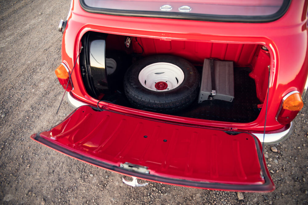 Spare tire in open trunk of red vintage car