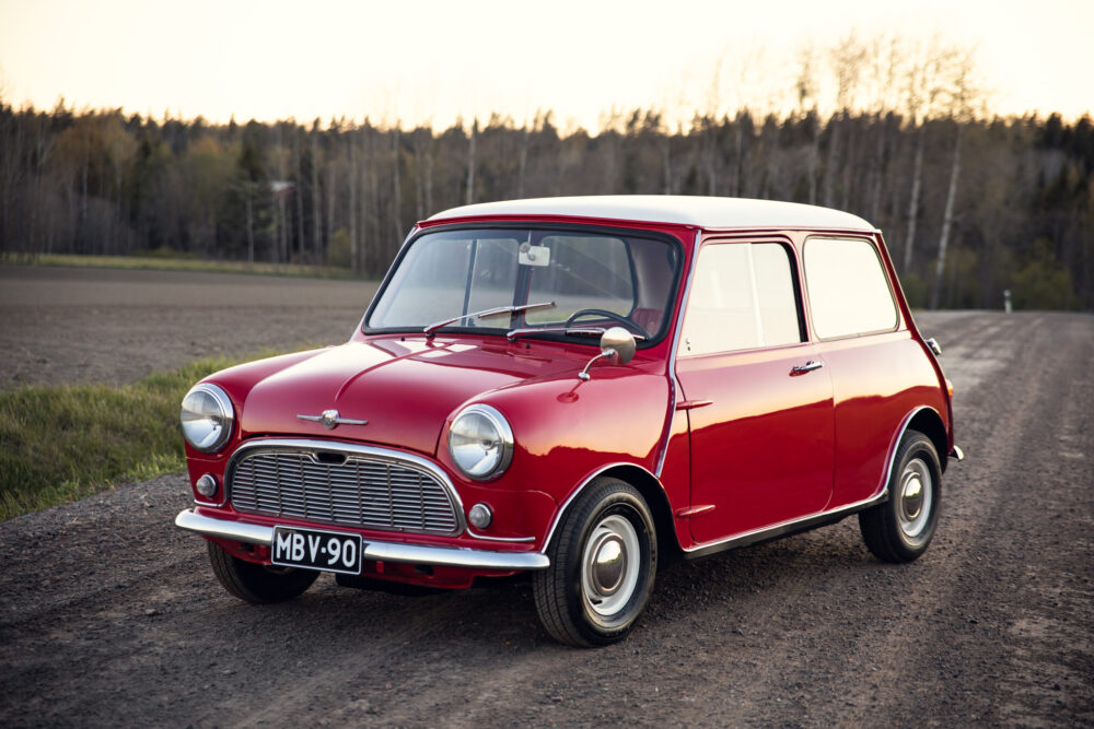 Vintage red Mini Cooper on rural road at dusk