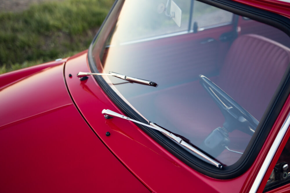 Close-up of red vintage car's windshield and wipers