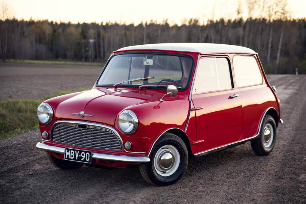 Vintage red Mini Cooper on rural road at dusk