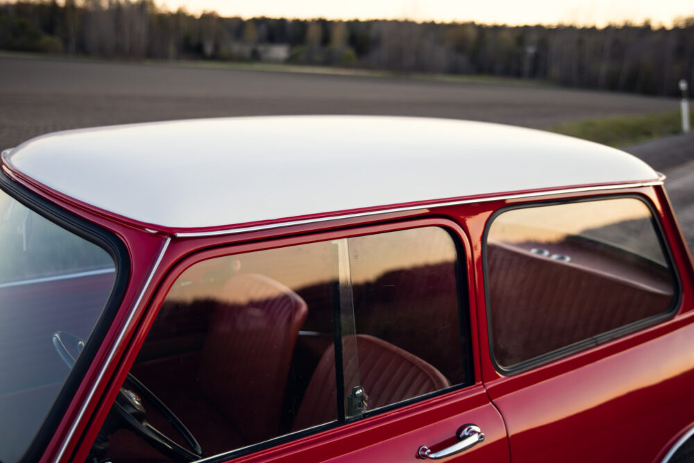 Red vintage car with white roof at dusk