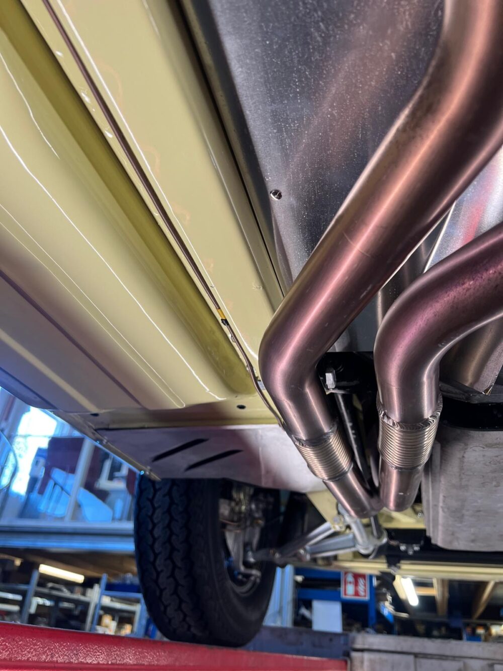 Undercarriage of car showing exhaust and suspension system