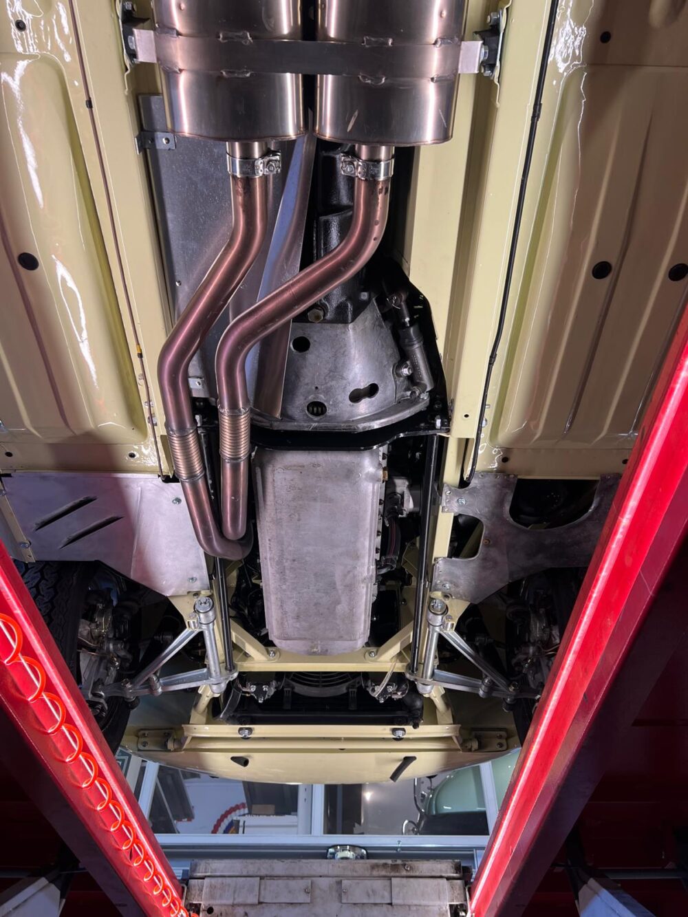 Undercarriage of car showing exhaust and suspension system
