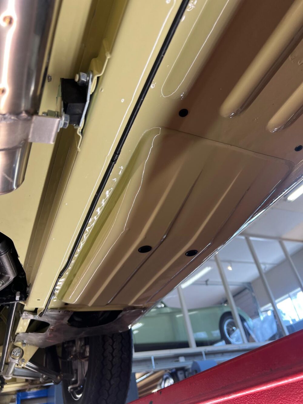 Undercarriage of a vintage car with detailed assembly