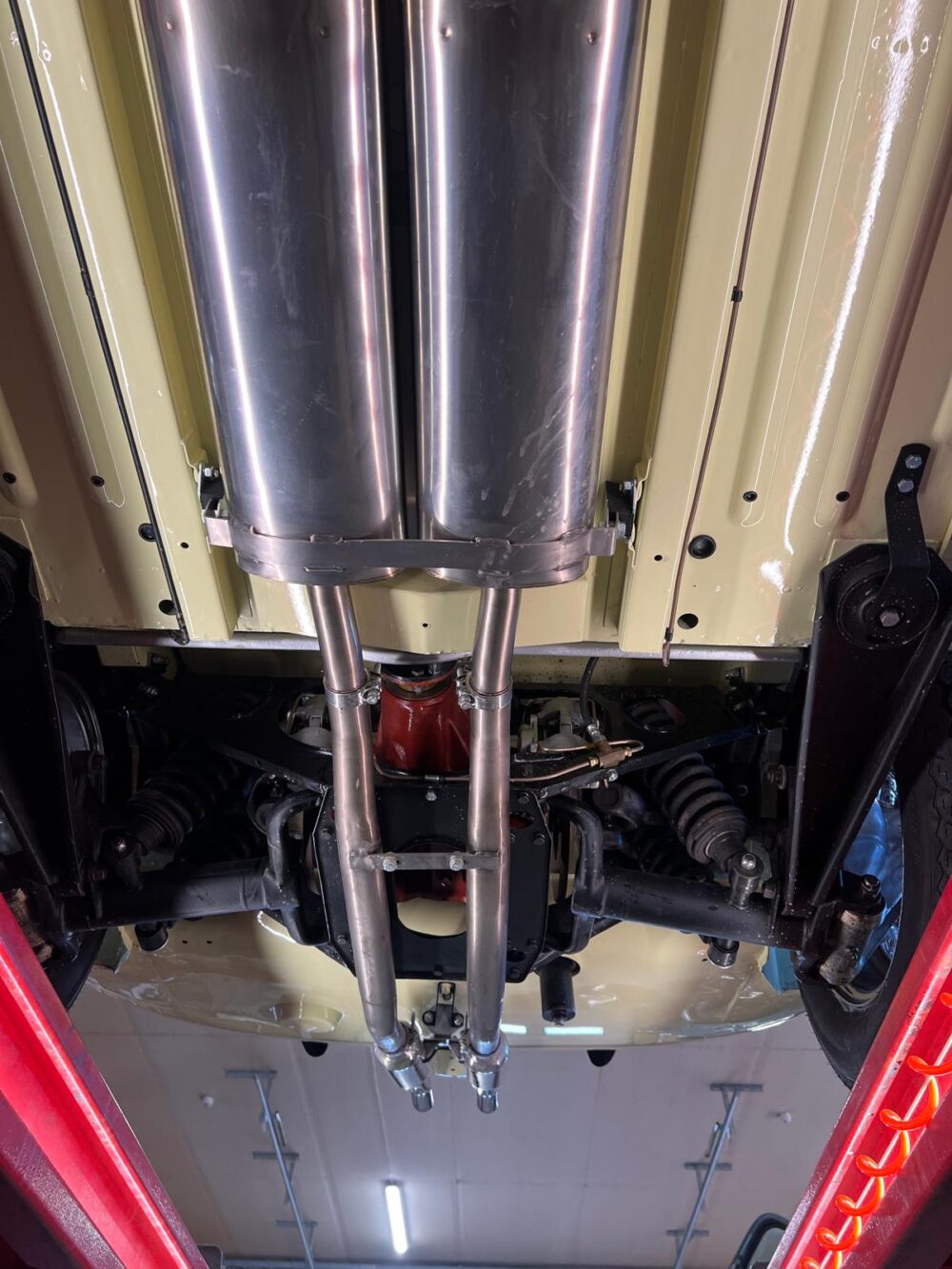 Undercarriage of a vehicle showing exhaust system and suspension
