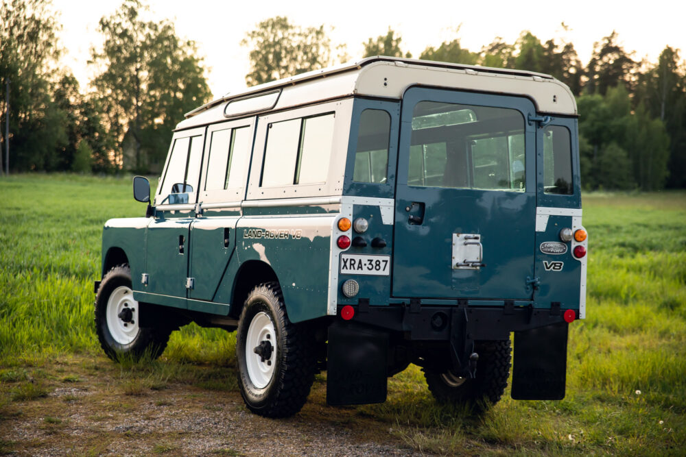 Vintage green Land Rover V8 in a grassy field