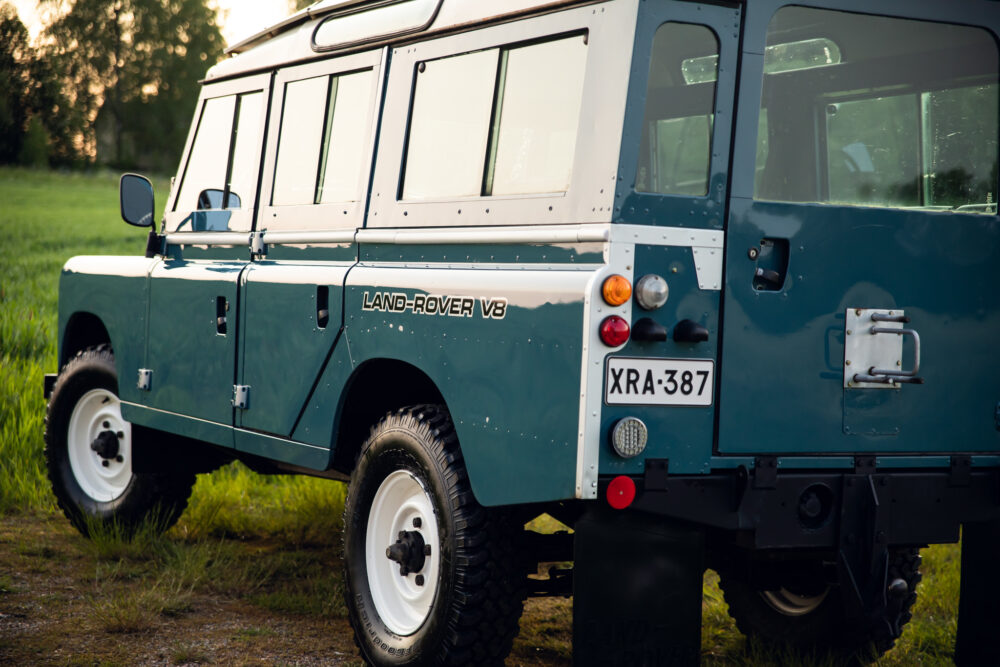 Vintage Land-Rover V8 parked in grassy field