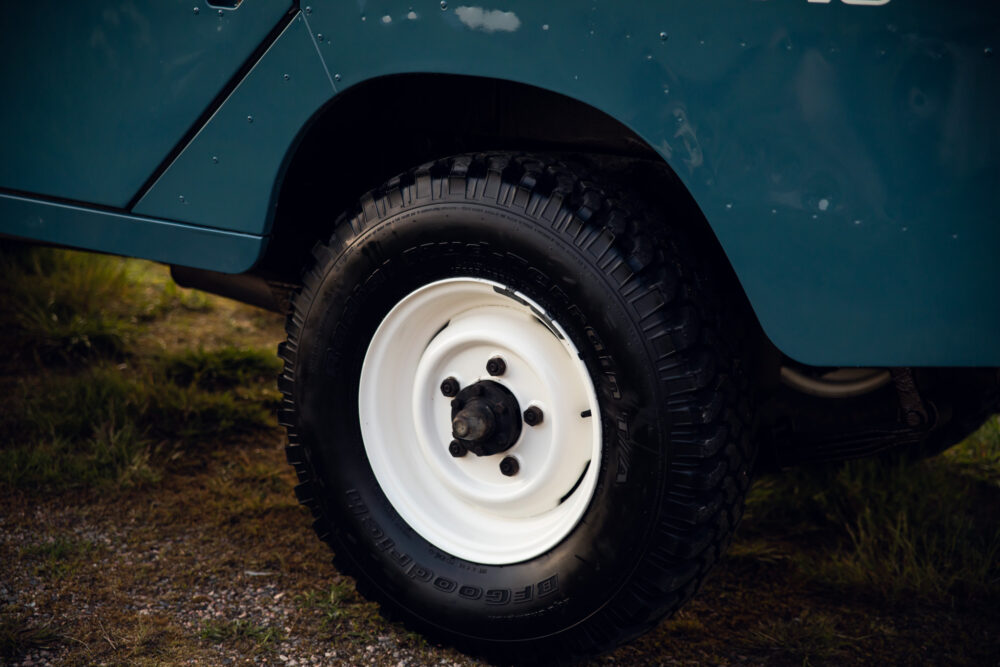 Close-up of vintage blue car's white wheel