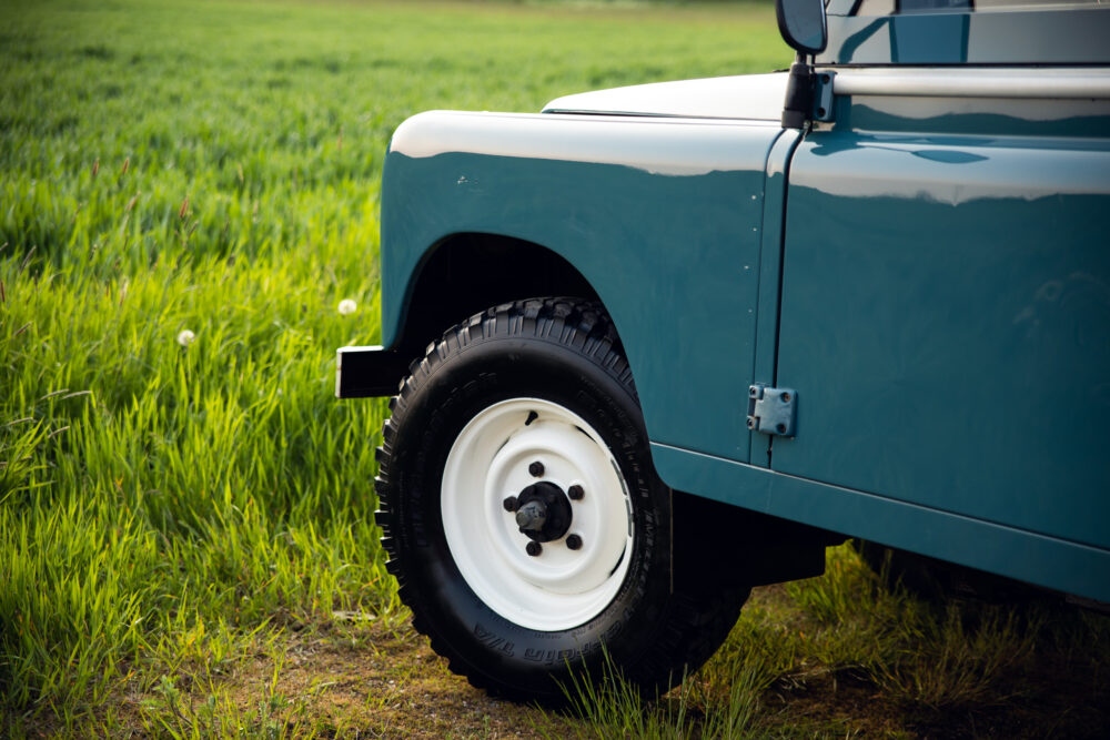 Close-up of teal off-road vehicle in grassy field