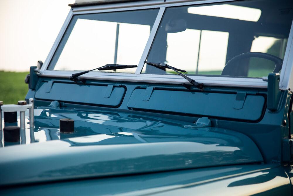 Close-up of blue jeep windshield and wipers