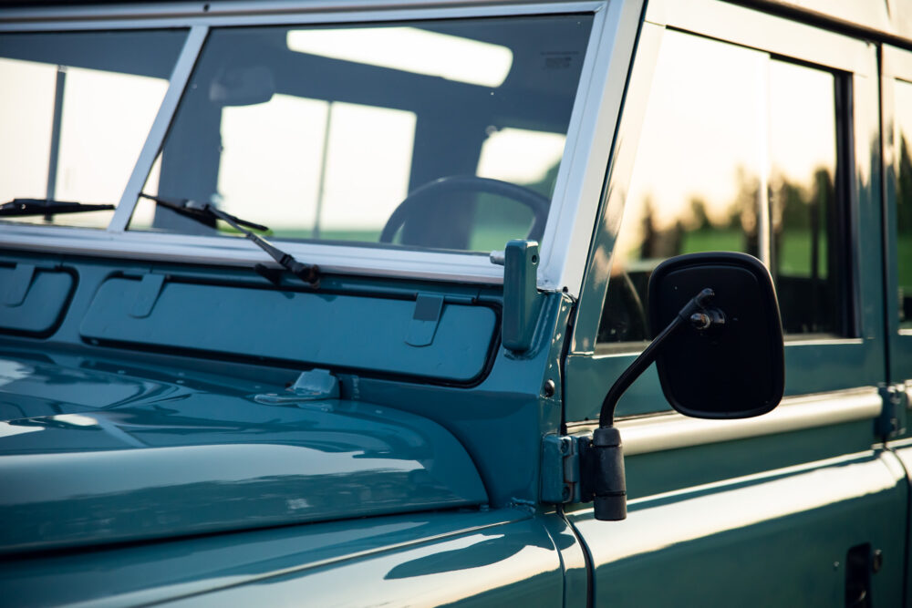 Close-up of turquoise vintage car side and mirror